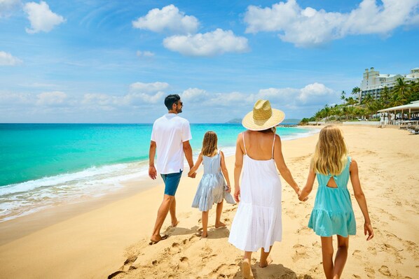 On the beach, white sand, beach cabanas, beach towels