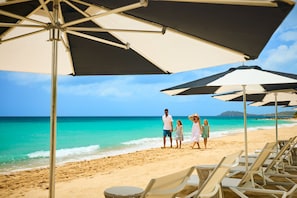 On the beach, white sand, beach cabanas, beach towels