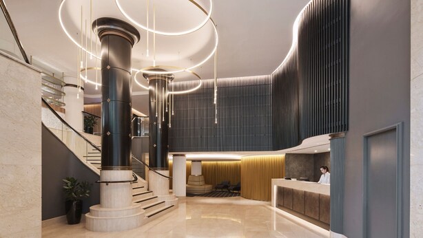 A modern lobby with a central column, a reception desk, and a staircase. - Rydges Darling Square Apartment Hotel (Sydney)