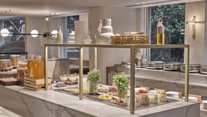A buffet setup with various food items and decorative elements. - Rydges Darling Square Apartment Hotel (Sydney)