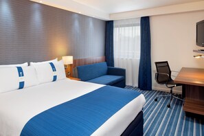 A hotel room with a large bed, a desk, a chair, and a television. - Holiday Inn Express London City by IHG (London)