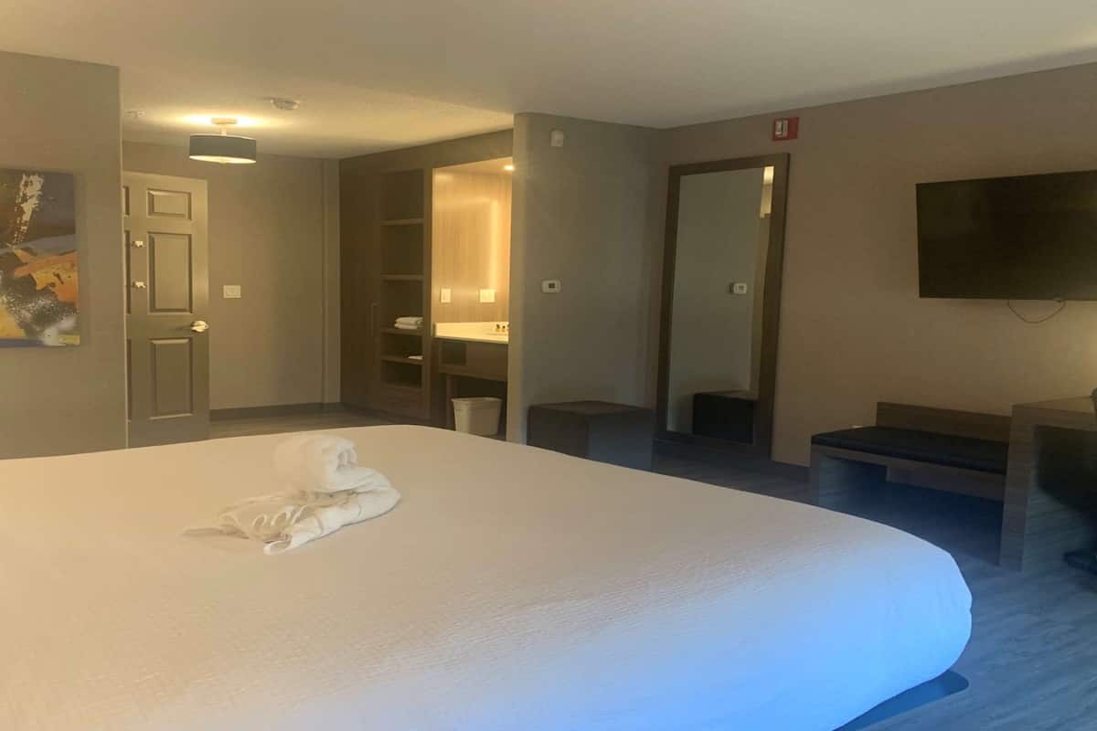 Premium bedding, desk, laptop workspace, blackout drapes