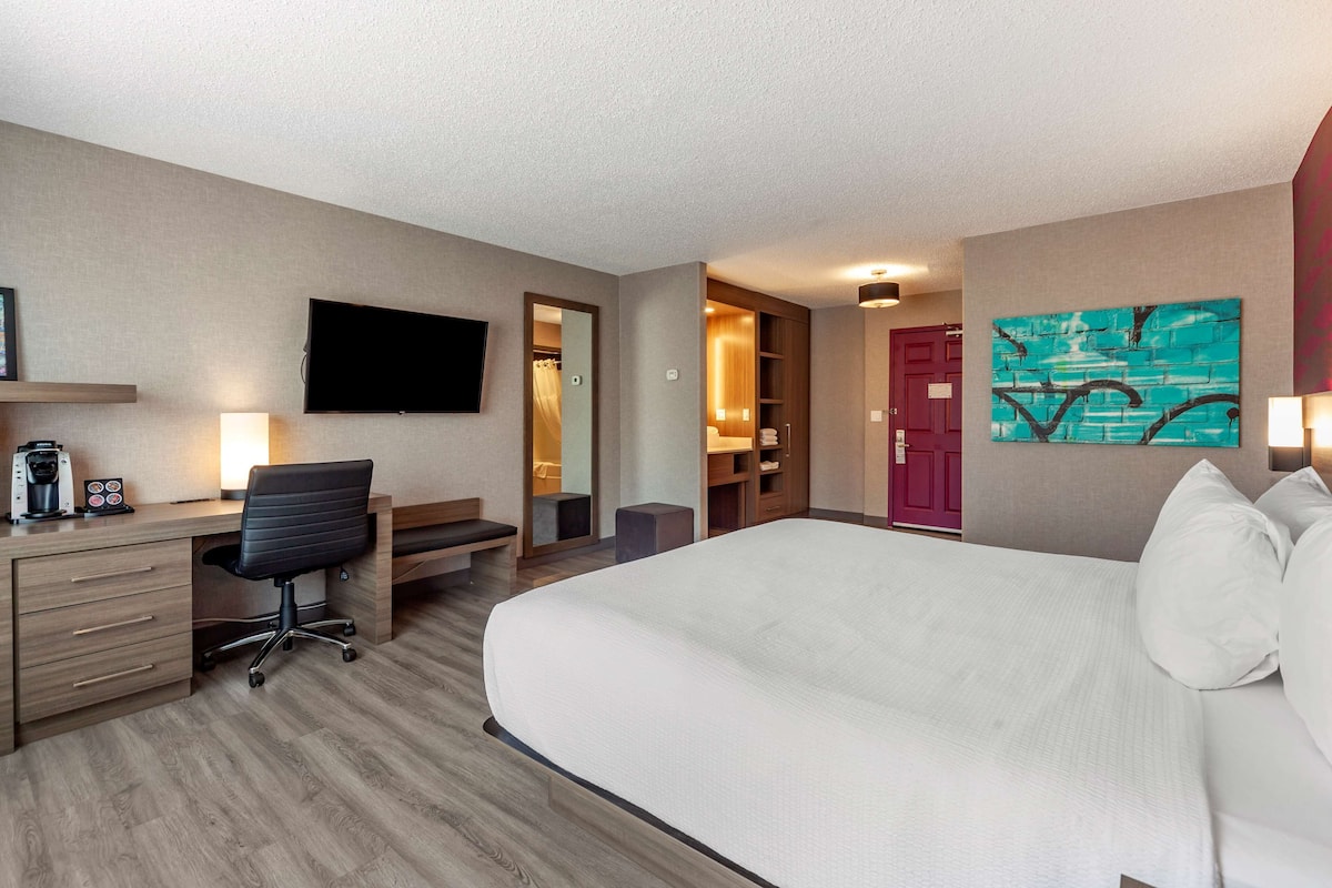 Premium bedding, desk, laptop workspace, blackout drapes