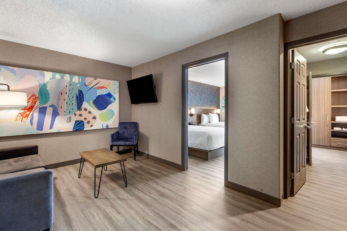 Premium bedding, desk, laptop workspace, blackout drapes