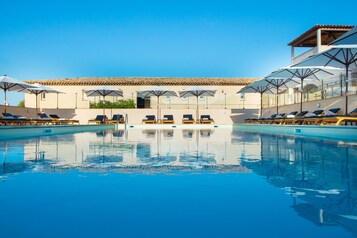Indoor pool, seasonal outdoor pool, pool umbrellas, pool loungers