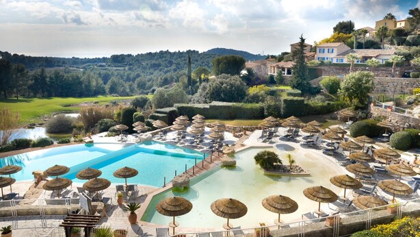 A resort with multiple swimming pools, lounge areas with umbrellas, and a scenic hillside view. - Le Frégate Provence (Saint-Cyr-sur-Mer)