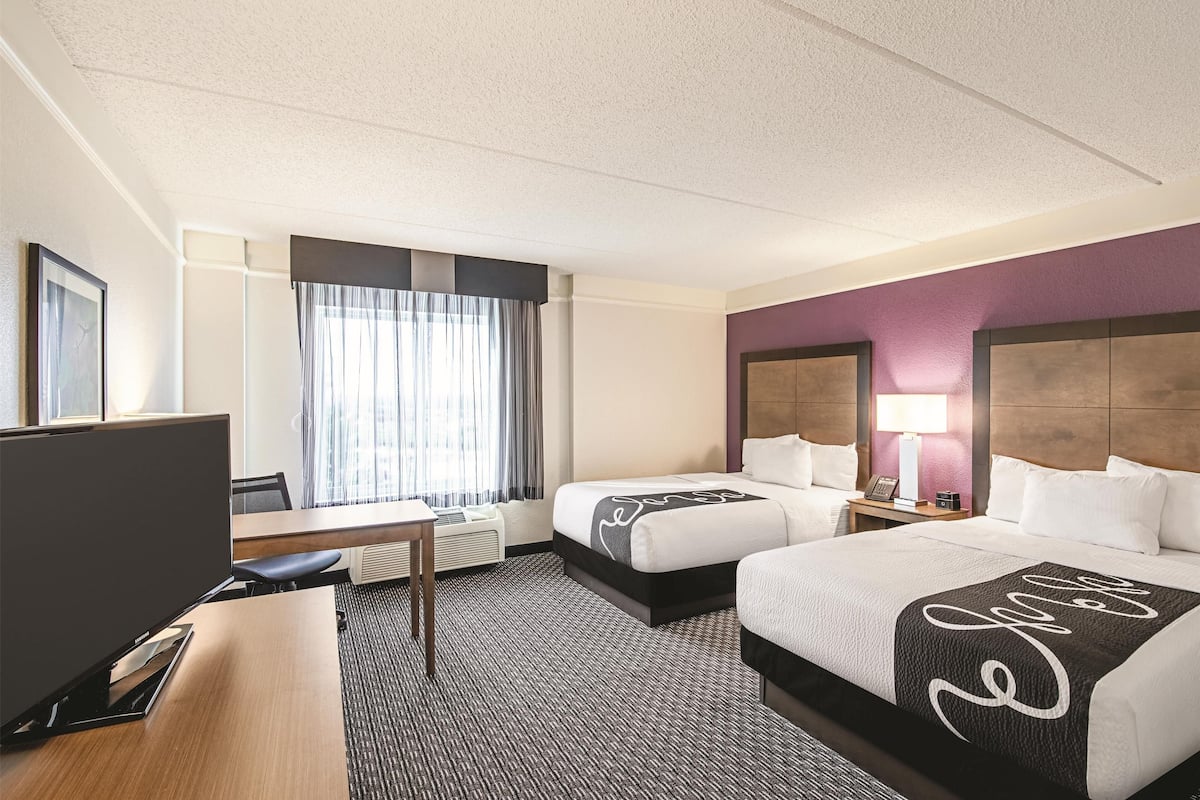 pillow-top beds, desk, laptop workspace, blackout curtains