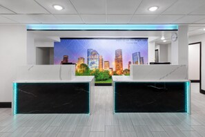 Welcome to our reception area, featuring a vibrant cityscape mural and a sleek reception desk.