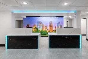 Welcome to our reception area, featuring a vibrant cityscape mural and a sleek reception desk.