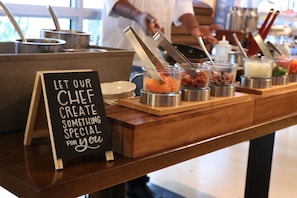 Indulge in a culinary experience with our chef's creations, served fresh from the buffet.