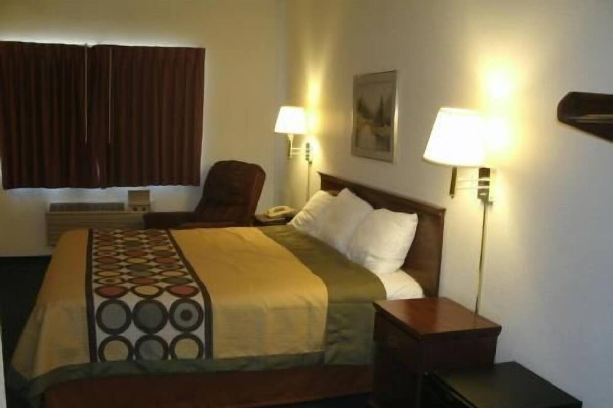 Desk, laptop workspace, blackout drapes, iron/ironing board