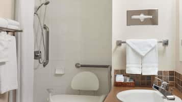A bathroom with a shower, toilet, and sink.