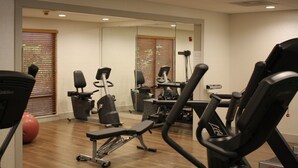 A gym with various exercise equipment, including treadmills and stationary bikes, and a large mirror on the wall. - Holiday Inn Express Atlanta NE I-85 Clairmont by IHG (Atlanta)