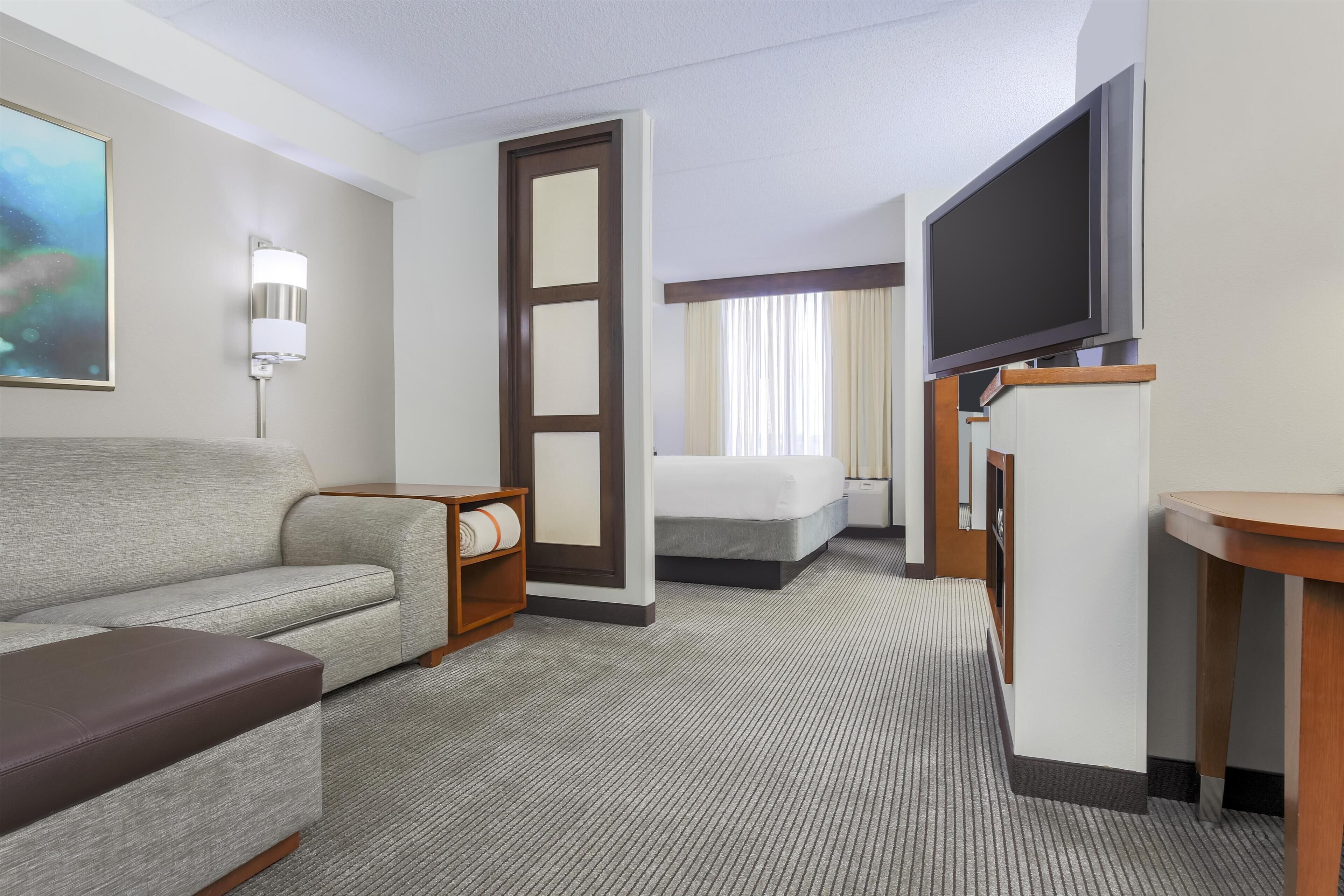Premium bedding, desk, laptop workspace, blackout drapes