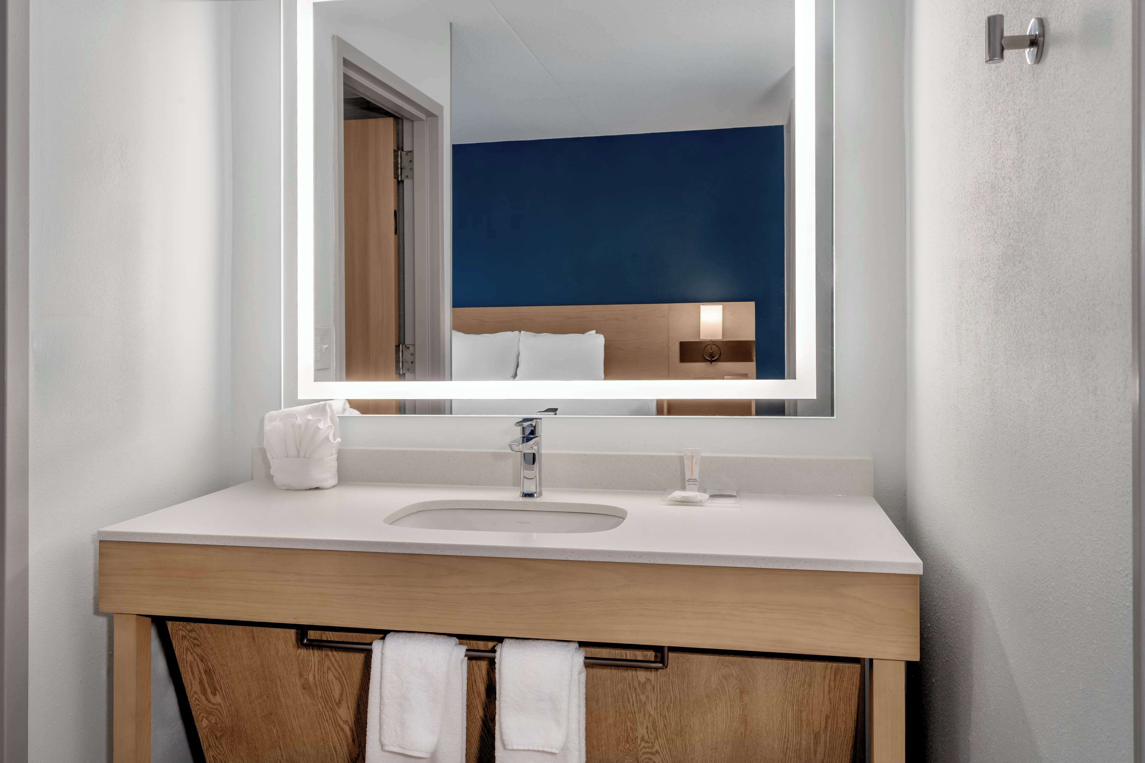 designer toiletries, hair dryer, towels, soap