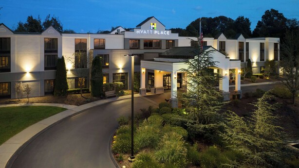 A modern hotel with a well-lit entrance, a covered outdoor area, and landscaped surroundings. - Hyatt Place Mystic (Mystic)
