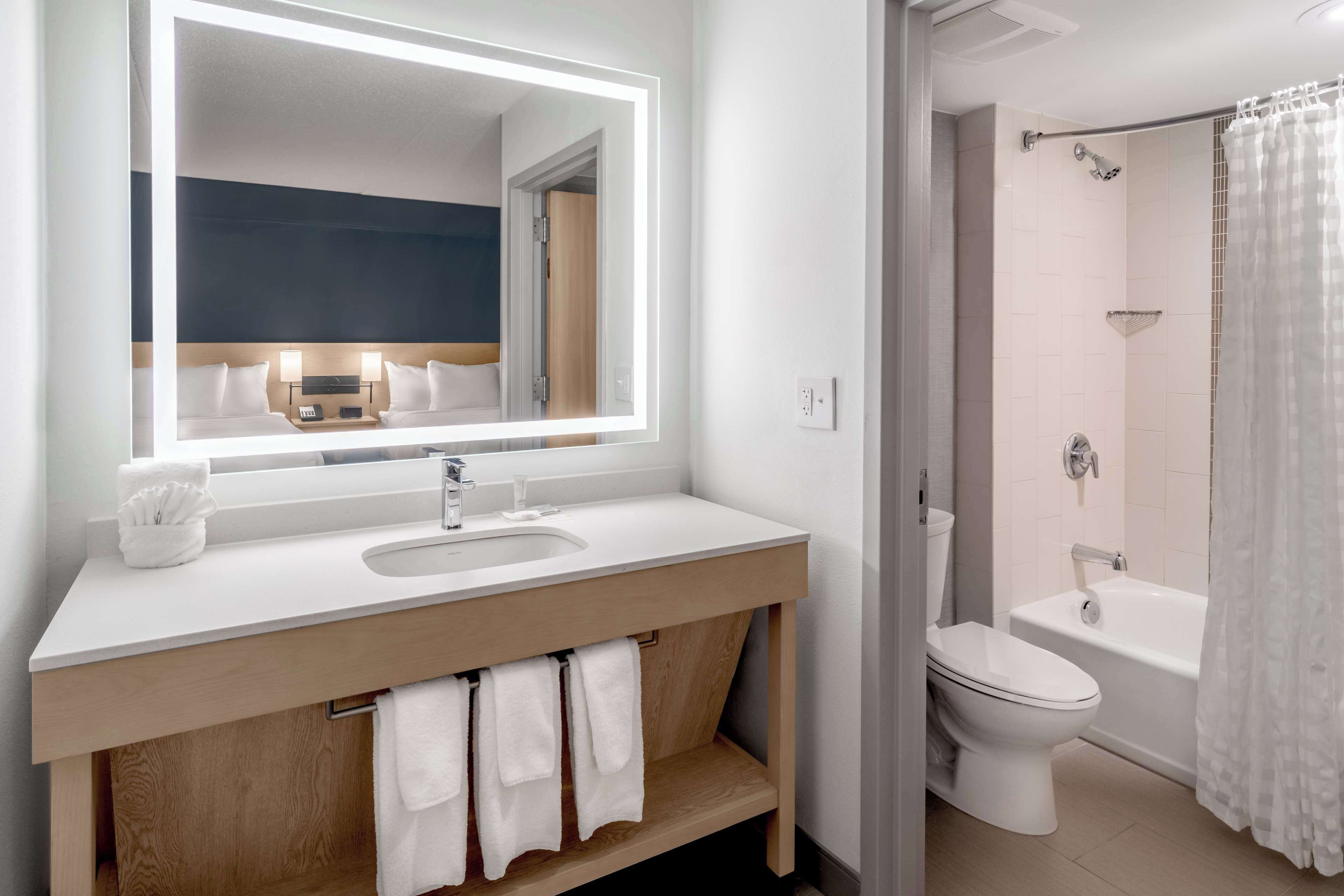 designer toiletries, hair dryer, towels, soap