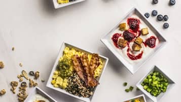 A variety of breakfast dishes arranged on a marble surface.