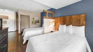 A hotel room with two beds, a wooden headboard, a desk, and a refrigerator. - Extended Stay America Premier Suites - Miami - Airport - Miami Springs (Miami Springs)