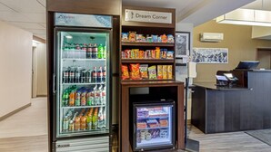 A hotel lobby with a refrigerated beverage display, a snack bar, and a reception desk. - Sleep Inn Denver Tech Center (Greenwood Village)