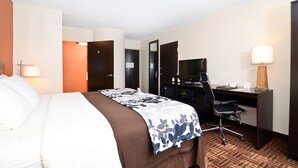 A hotel room with a bed, desk, chair, and a TV. - Sleep Inn O'Fallon near I-64 (O'Fallon)