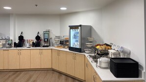 A modern kitchen with a coffee station, a refrigerator, and a buffet area. - Sleep Inn Staunton (Staunton)