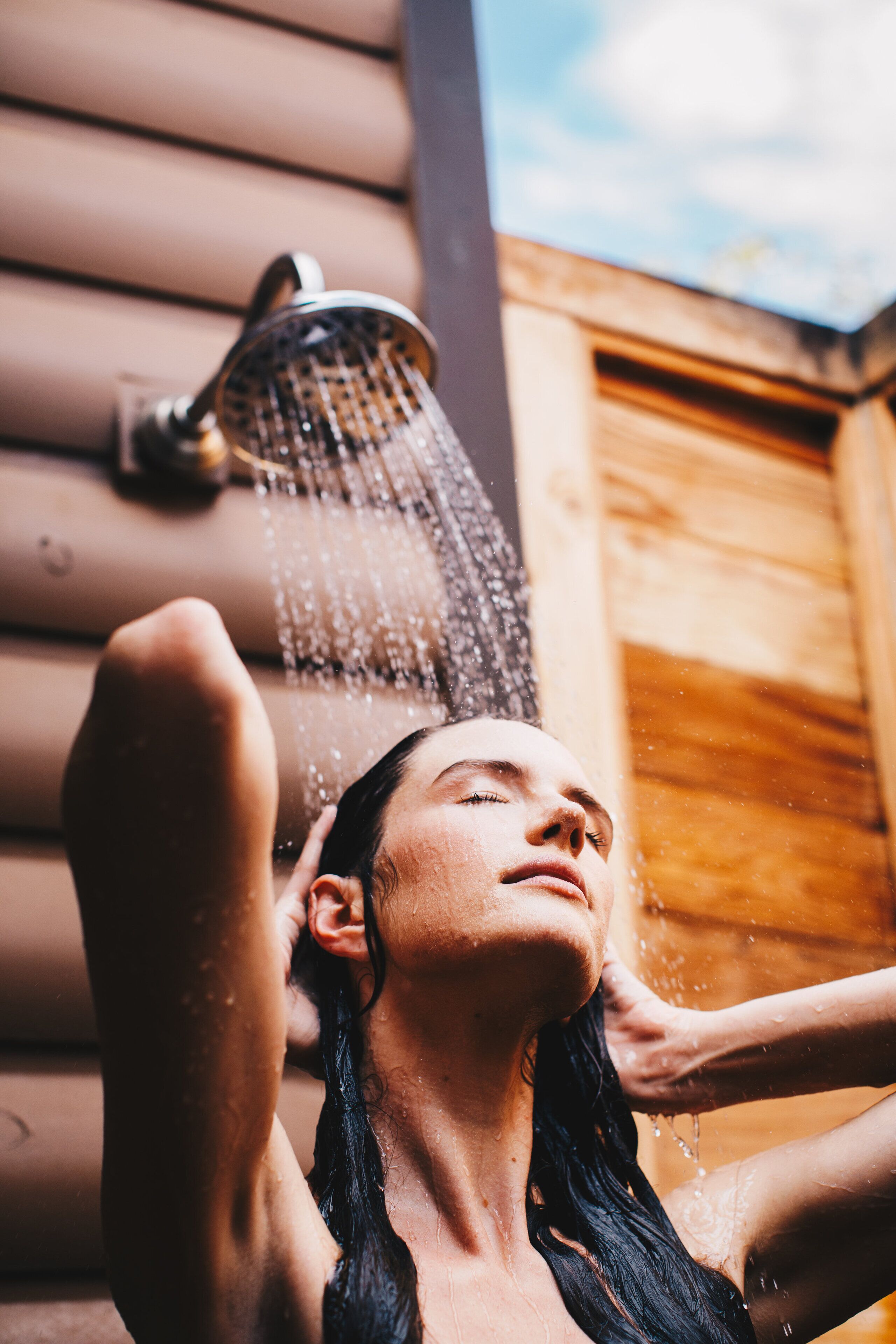 A person under a shower with water flowing.