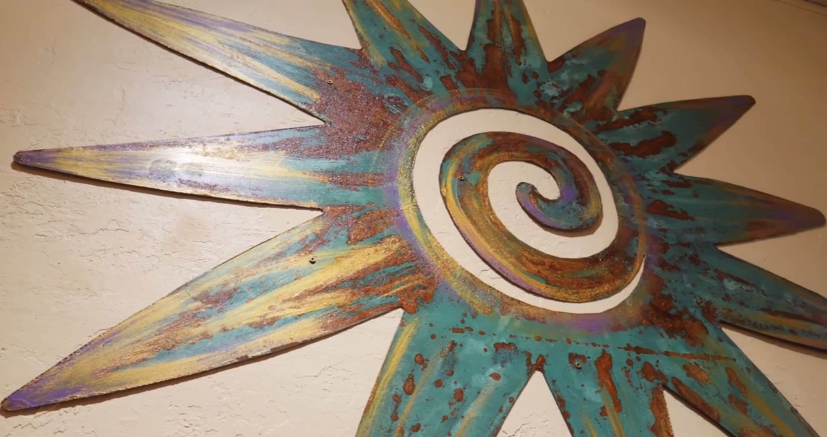 A star-shaped metal wall decoration with a spiral center.