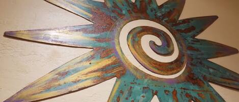 A star-shaped metal wall decoration with a spiral center.