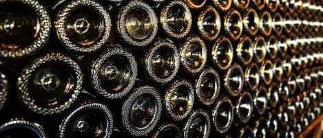 A close-up of numerous cylindrical objects with reflective surfaces, arranged in a repetitive pattern.