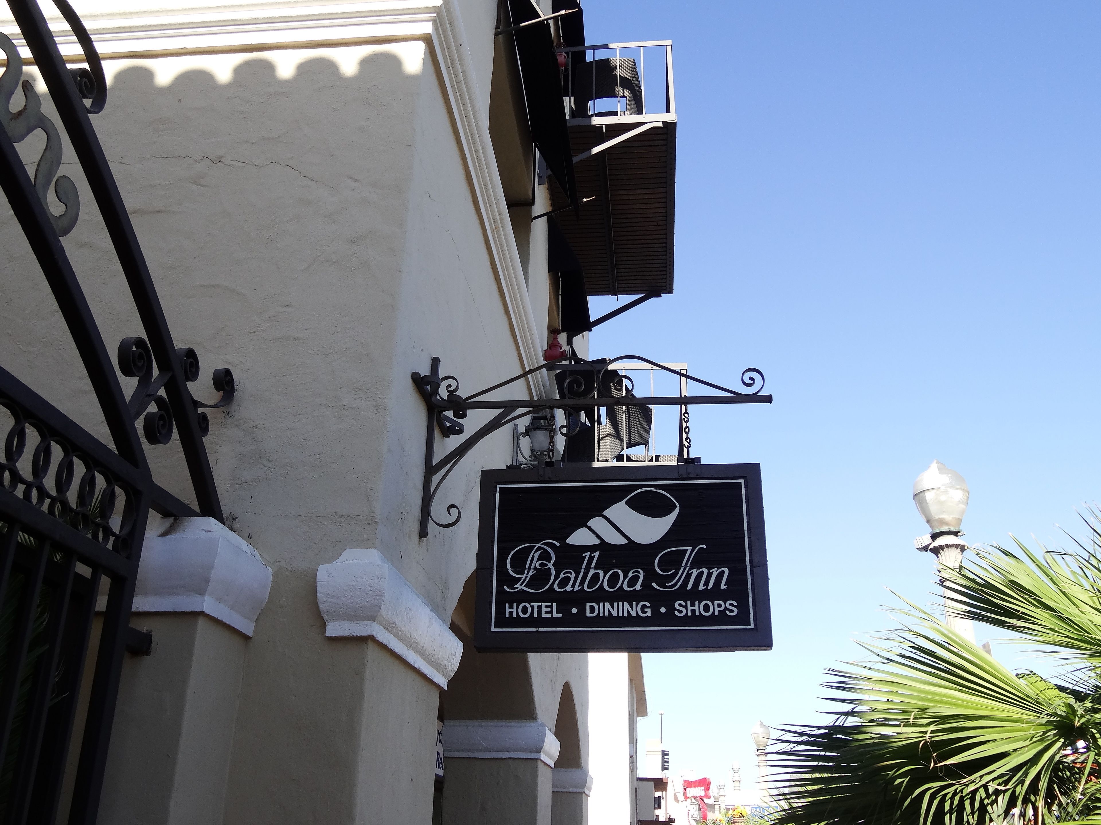 A sign for Balboa Inn, indicating it offers hotel, dining, and shops.