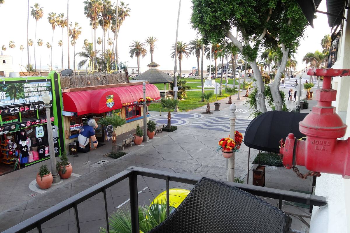 A street view with a taco stand, a green storefront, and a red fire hydrant.