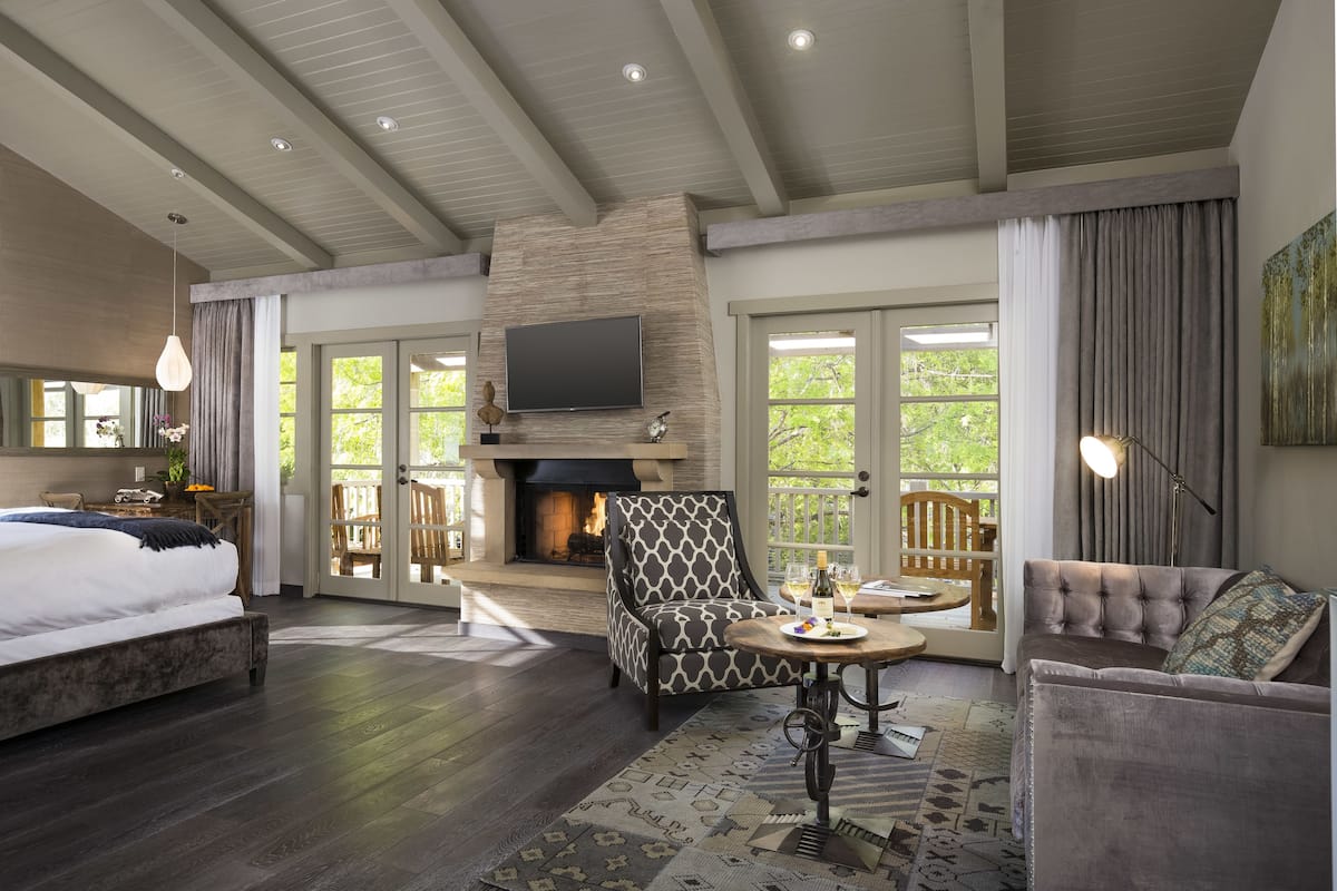 A spacious living room with a fireplace, a large TV, and comfortable seating.