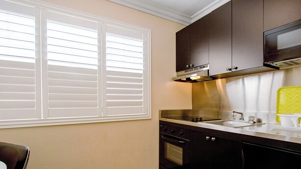 A kitchen with a window, a stove, and a microwave. - Red Roof Inn & Suites Monterey (Monterey)