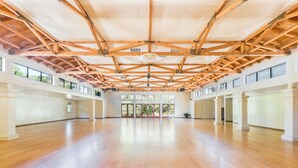 A spacious hall with a high wooden ceiling and large windows. - The Pierpont Inn (Ventura)