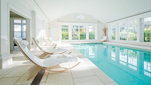 A large indoor swimming pool with clear blue water, surrounded by white walls and large windows. - Mayflower Inn & Spa, Auberge Collection (Washington)