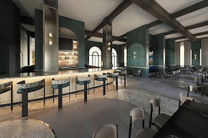 A spacious bar area with high ceilings and large windows, featuring a bar counter and seating. - Gulfstream Hotel (Lake Worth)