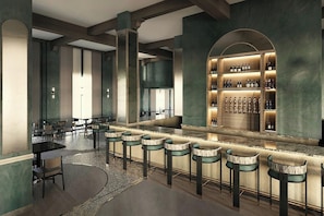 A bar area with a long counter, multiple stools, and a wine display. - Gulfstream Hotel (Lake Worth)