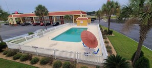 A motel with a swimming pool, a fenced patio area, and a parking lot. - Red Roof Inn Tifton (Tifton)