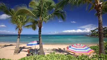 On the beach, white sand, sun loungers, beach towels