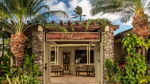 A wooden entrance with a sign reading "The Mauian" and two benches in front. - The Mauian - Boutique Beach Studios on Napili Bay (Lahaina)