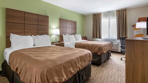 A hotel room with two beds, a desk, and a window with curtains. - Quality Inn Creston (Creston)