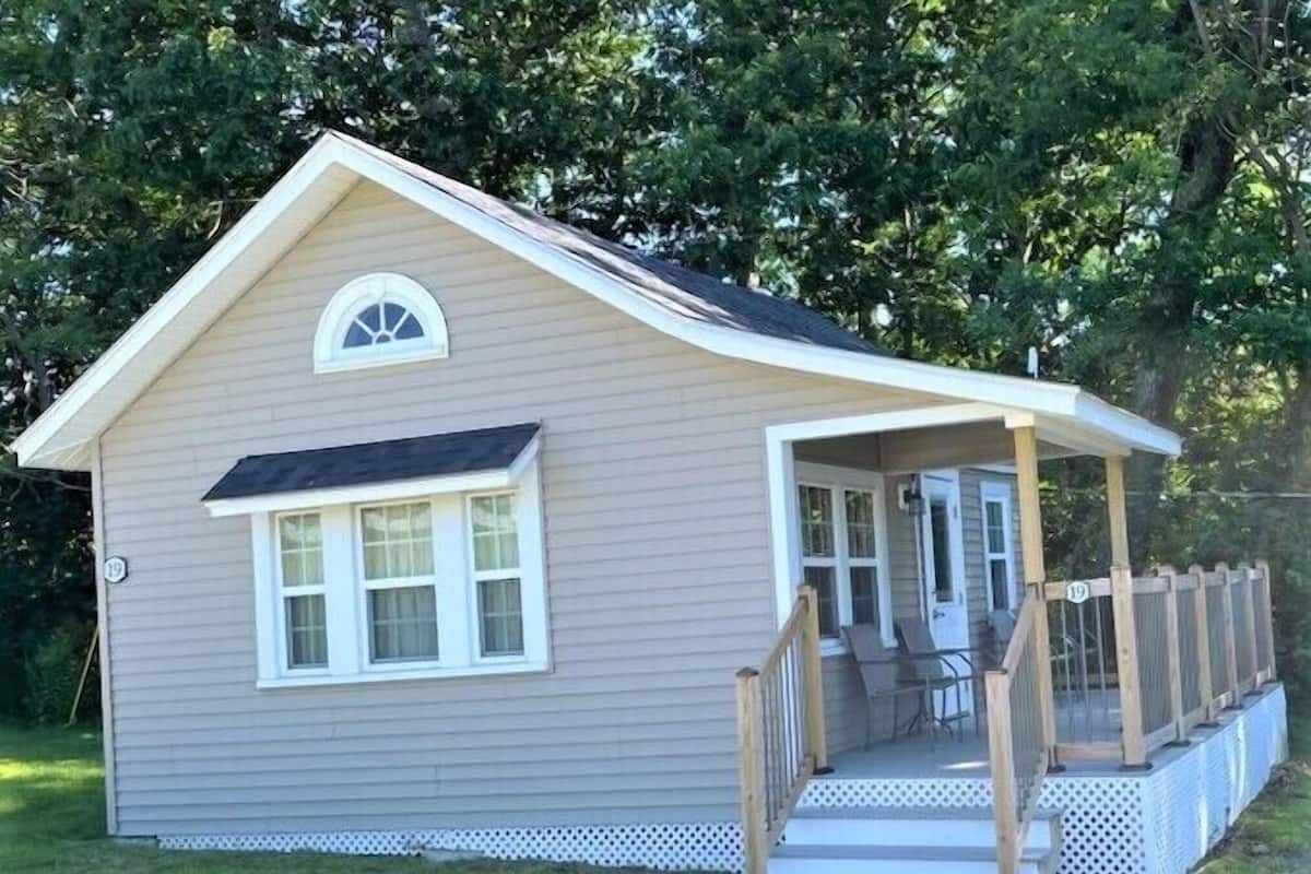 A small, single-story house with a porch and a covered entryway.