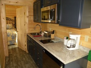 A compact kitchen with a microwave, toaster, and coffee maker.
