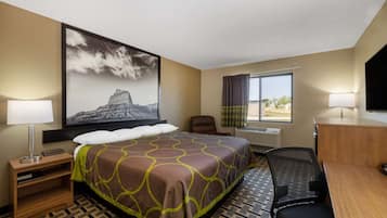Relax in comfort with a large bed, flat-screen TV, and desk workspace.