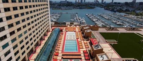 A high-rise hotel with a rooftop pool and marina views.