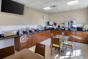 A kitchen with wooden cabinets, a microwave, a coffee machine, and a refrigerator. - Best Western Hendersonville Inn (Hendersonville)