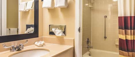 A bathroom with a sink, mirror, towel rack, and a shower with a curtain.
