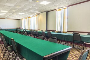 A conference room with long tables and chairs, a projector screen, and windows with curtains. - Red Roof Inn Ashtabula - Austinburg (Austinburg)