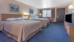 A hotel room with two beds, a desk, a chair, a television, and two paintings on the wall. - Travelodge by Wyndham Pioneer Villa (Halsey)